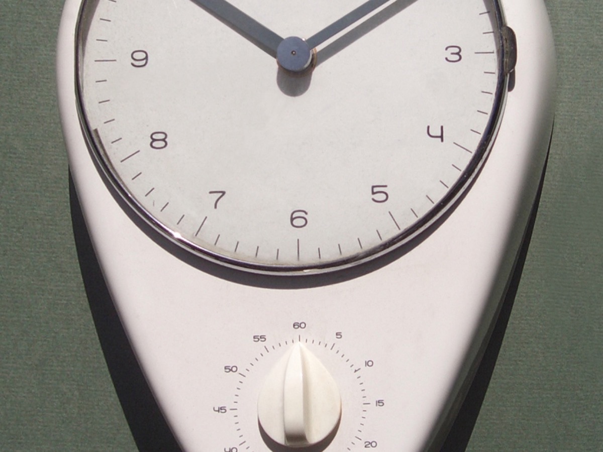 The Max Bill kitchen clock for Junghans, a white ceramic face with a timer below